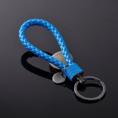 Nouveau porte-clés en corde tressée en acier au tungstène, porte-clés en cuir, pendentif de poupée fait à la main, cadeau de fête, petits bijoux